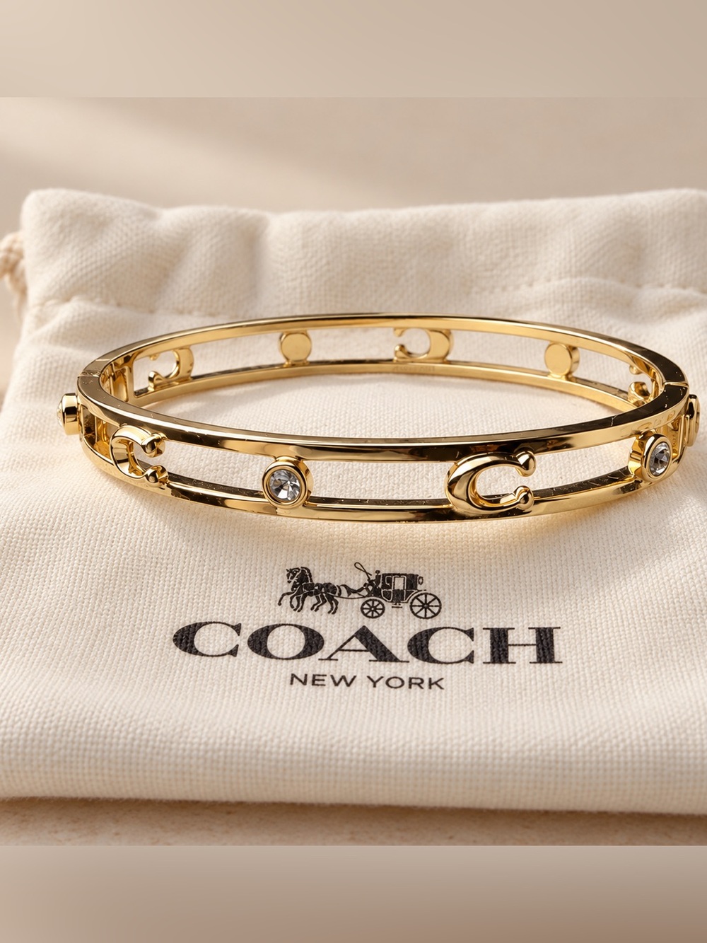 Coach Gold-Tone Hinged Bangle Bracelet with Crystal Accents
